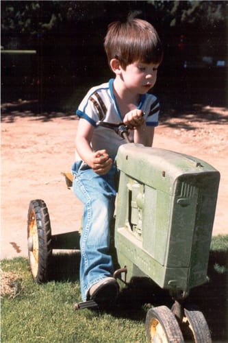 child driving toy tractor