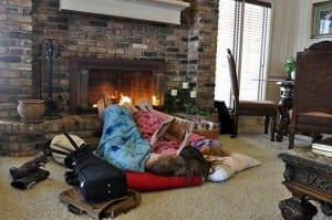 the three youngest kids reading at the fire