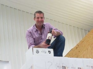 man on pallet of wine cases