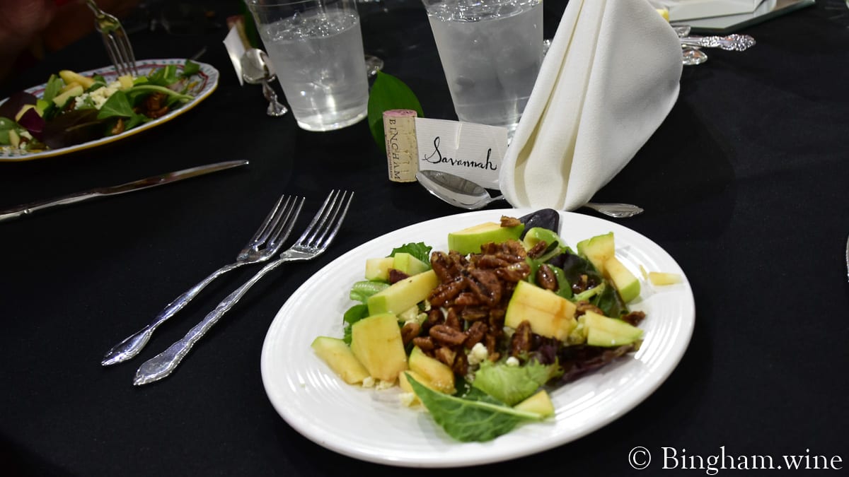 19.07.27_untitled_117-1200x675(16x9) | Bingham Family Vineyards table setting with plates of salad for bingham family vineyard wine club dinner barrel room meadow Texas