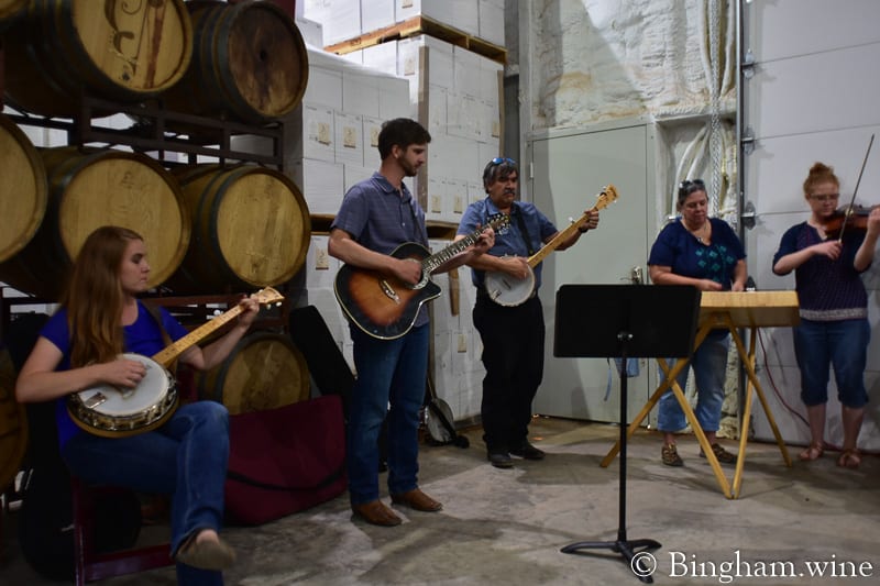 19.07.27_untitled_150-800web.4.5 | Bingham Family Vineyards people playing music at bingham family vineyard wine club dinner barrel room meadow Texas