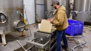 Daniel setting up filter at the bingham family vineyards winery