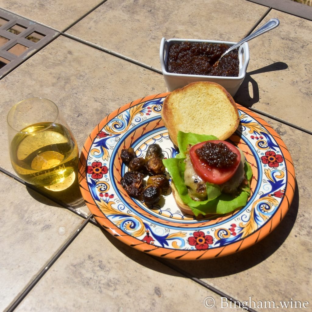 20.06.10_BourbonOnionJam18Roussanne_017.1200.web_.1x1 | Bingham Family Vineyards onion jam tomatoes lettuce burger with glass of wine