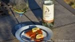 bottle of bingham family vineyards Cloudburst and glass of wine with salmon roasted red pepper