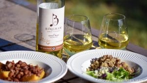 dishes of food with a bottle of bingham family vineyards 2019 short rows and wine glasses