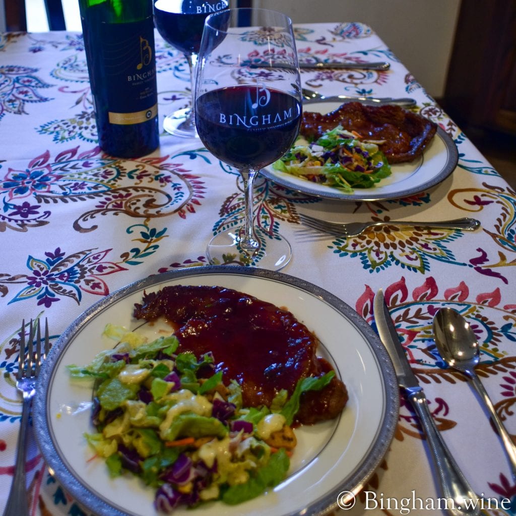 20.07.17_R.Merlot.Steak_.HotGlaze_003.1200.web_.1x1 | Bingham Family Vineyards steak dinner with a bottle of bingham family vineyards 2015 reserve merlot and wine glass