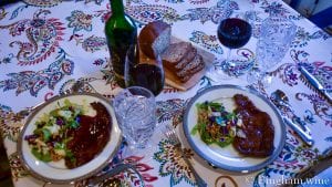 steak dinner with a bottle of bingham family vineyards 2015 reserve merlot and wine glass