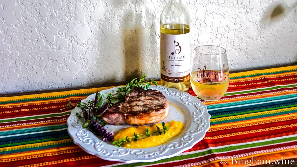 fullsizeoutput_84d-Trebbiano-1200-web-16x9-2 | Bingham Family Vineyards steak and mango salsa with a bottle of bingham family vineyards 2018 Trebbiano and glass of wine