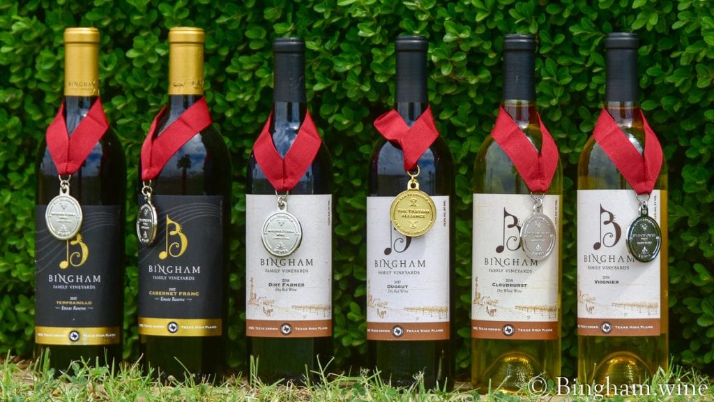 21.05.26_untitled_008-1200-web-16x9-1 | Bingham Family Vineyards Bingham Family Vineyards wine bottles with medals hanging on them.