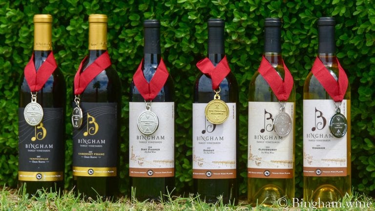Bingham Family Vineyards wine bottles with medals hanging on them.
