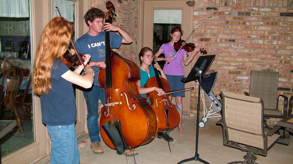 090712_grapetastingclass_051-1200-web-16x9 | Bingham Family Vineyards Several of Cliff and Betty Bingham's children playing music on the back porch