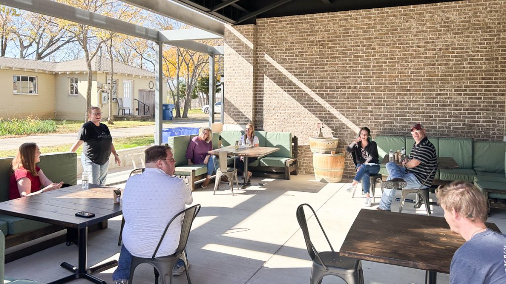 23.12.08_Roanoke.Jenn.Chase3_003-1200-web-16x9 | Bingham Family Vineyards People seated in the patio enjoying a sneak preview of Bingham Family Vineyards, Roanoke, Texas, location