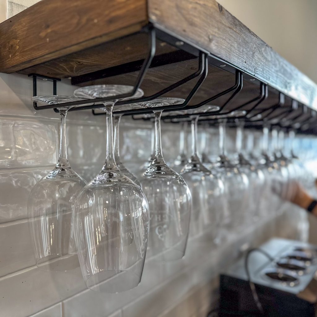23.12.08_Roanoke.Jenn.Chase_006.1200.web.1x1 | Bingham Family Vineyards glasses hanging from shelf at Bingham Family Vineyards, Roanoke, Texas