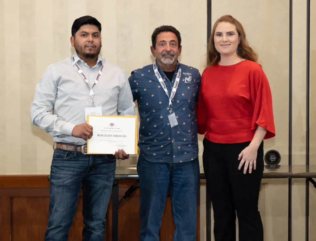 Scholarhsip | Bingham Family Vineyards Rogelio Orocio excepting the Blake Eddie Scholarship from the president of the Texas Hill Country Winery Association and Marissa Bingham-Dodson
