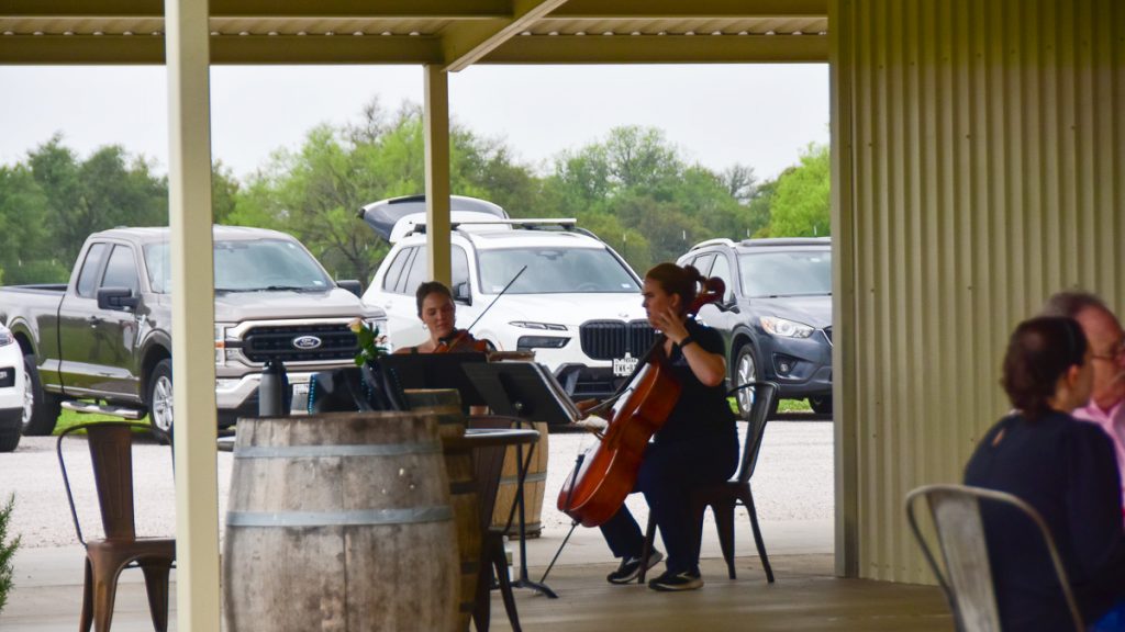 240408_HyeEclipse_021-1200-web-16x9 | Bingham Family Vineyards Binghams playing music on the patio at solar eclipse on April 8, 2024 at Bingham Family Vineyards, Hye, Texas