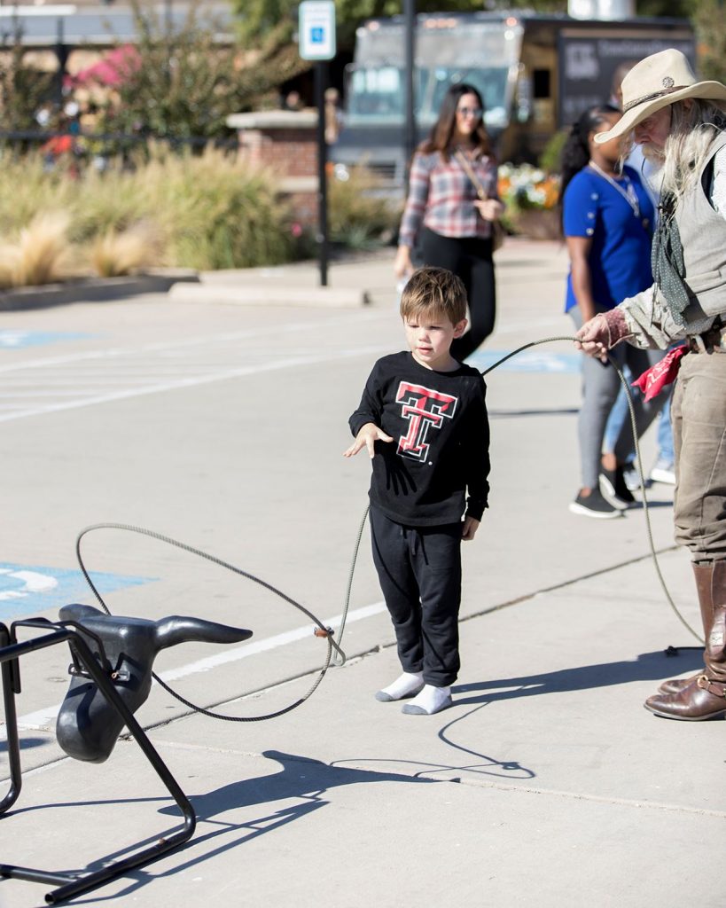 CelebrateRoanoke20233 | Bingham Family Vineyards cowboy teaching child how to rope a steer at Celebrate Roanoke, Texas