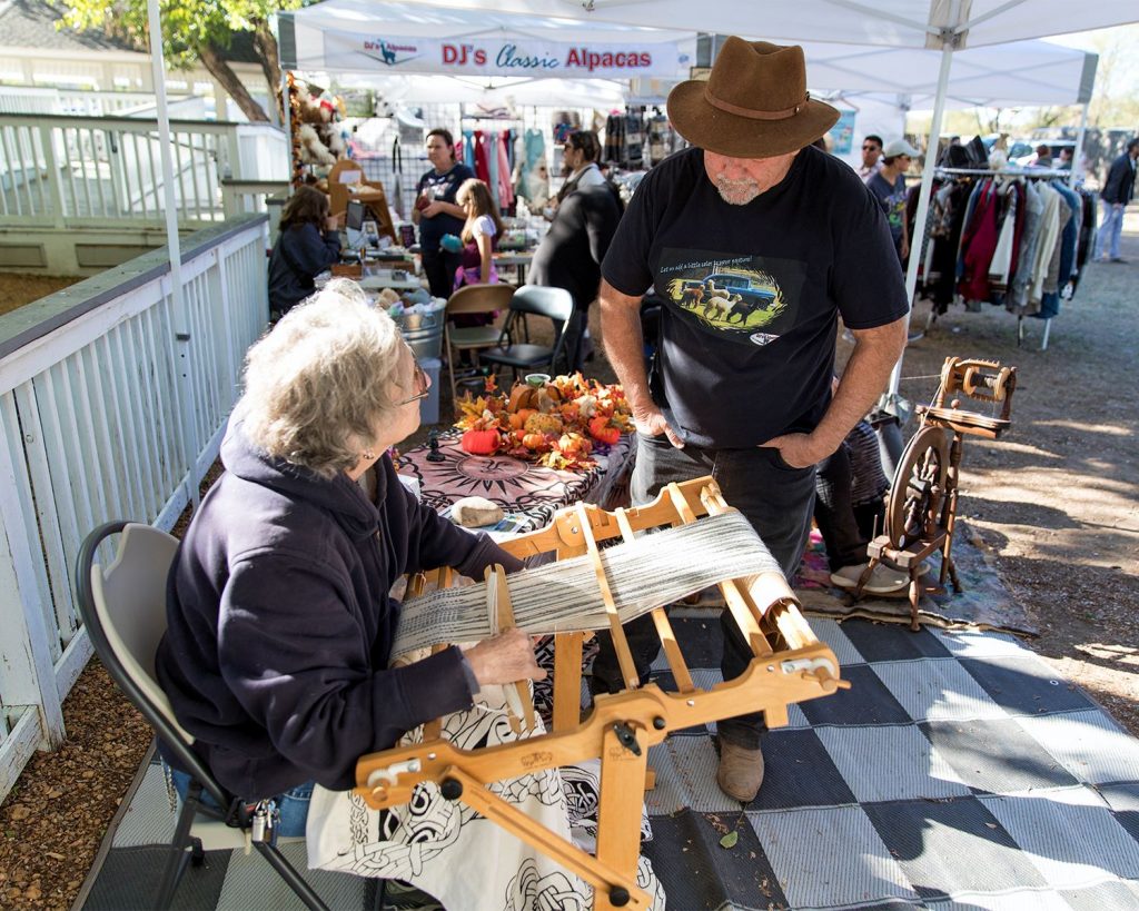 CelebrateRoanoke20234 | Bingham Family Vineyards woman weaving at booth on Oak Street at Celebrate Roanoke, Texas