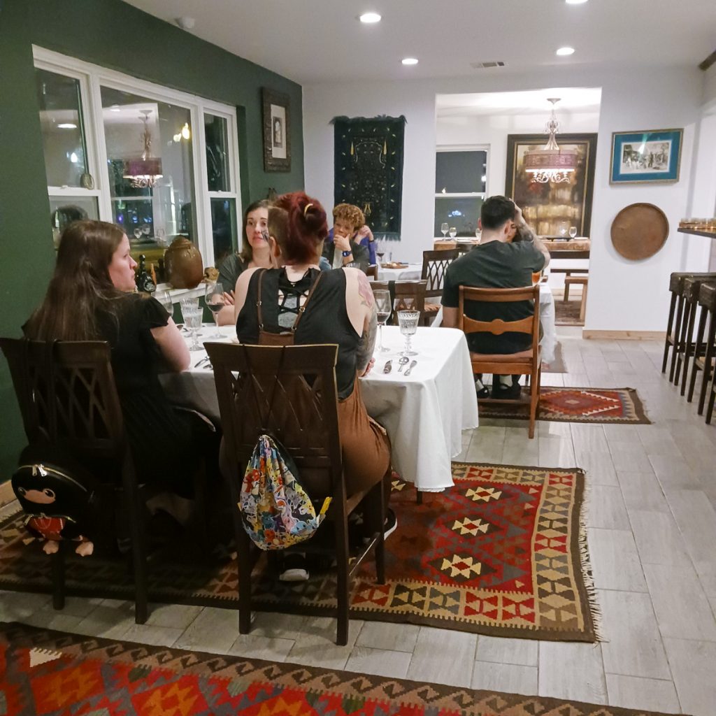 250313_ChefHouse_0011200web1x1 | Bingham Family Vineyards People seated at various tables at Chef House, Roanoke, Texas for a five course food and wine meal with wine from Bingham Family Vineyards.