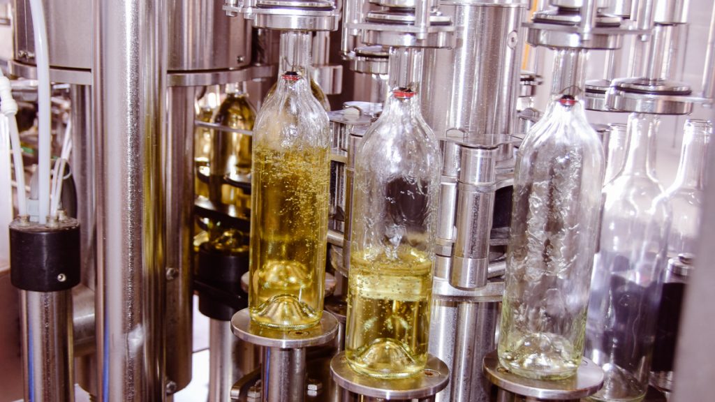 bottles being filled with white wine at Bingham Family Vineyards