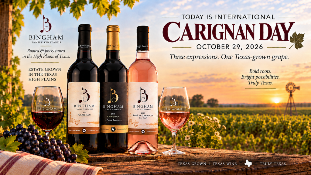 Bingham Family Vineyards 2021 Carignan, 2021 Estate Reserve Carignan, and Rosé of Carignan stand on a rustic wooden table with glasses of red and rosé wine, grapes, and flowers against a vineyard sunset. Text reads “Today is International Carignan Day,” “October 29, 2026,” and “Three expressions. One Texas-grown grape.”