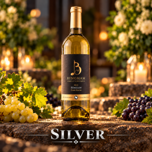 Bingham Family Vineyards 2023 Reserve Sémillon, Silver award winner at the 2026 San Francisco International Wine Competition, displayed on rustic stone with grape clusters, greenery, white flowers, and warm decorative lighting.